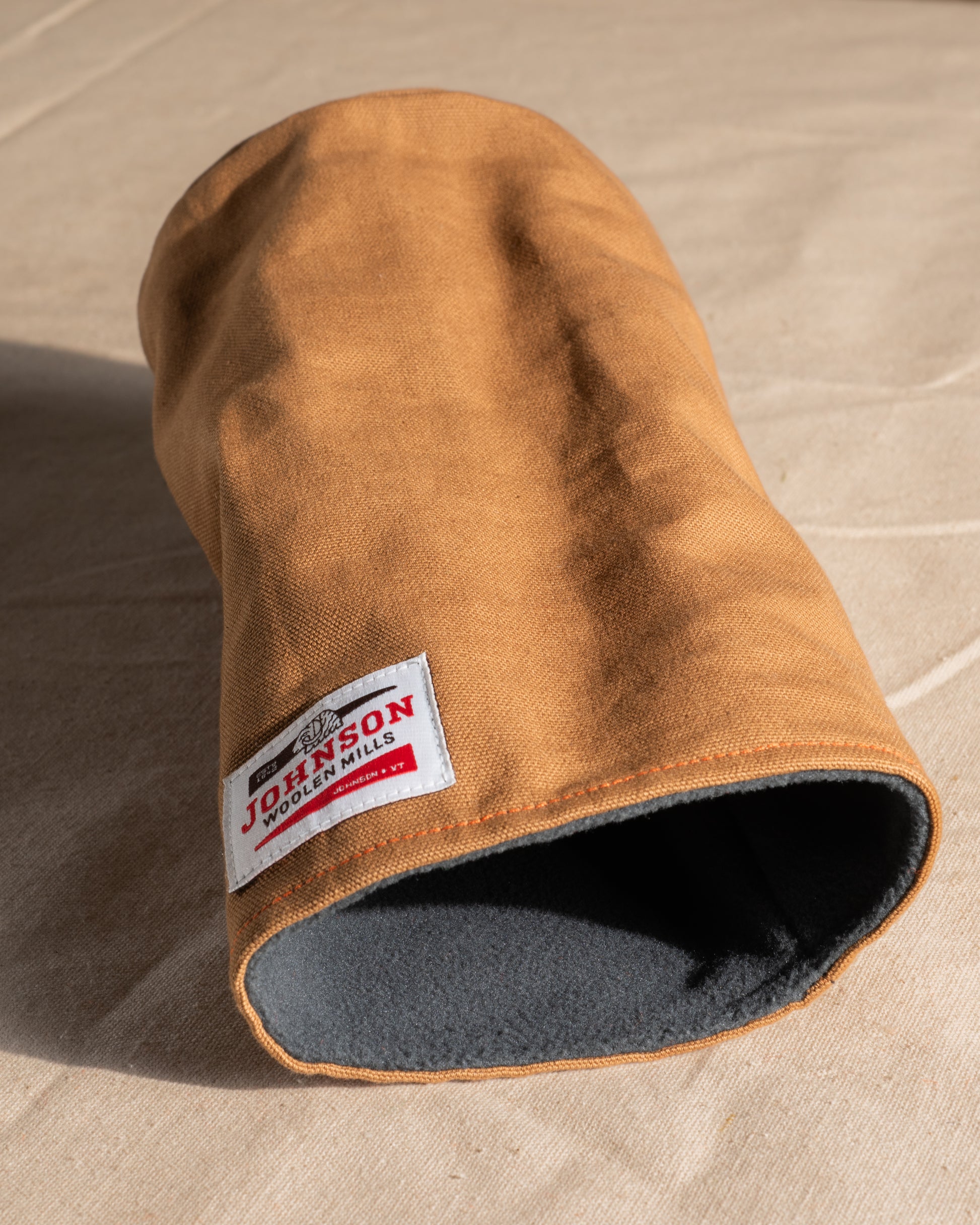Brown canvas driver headcover with a Johnson logo on a beige background