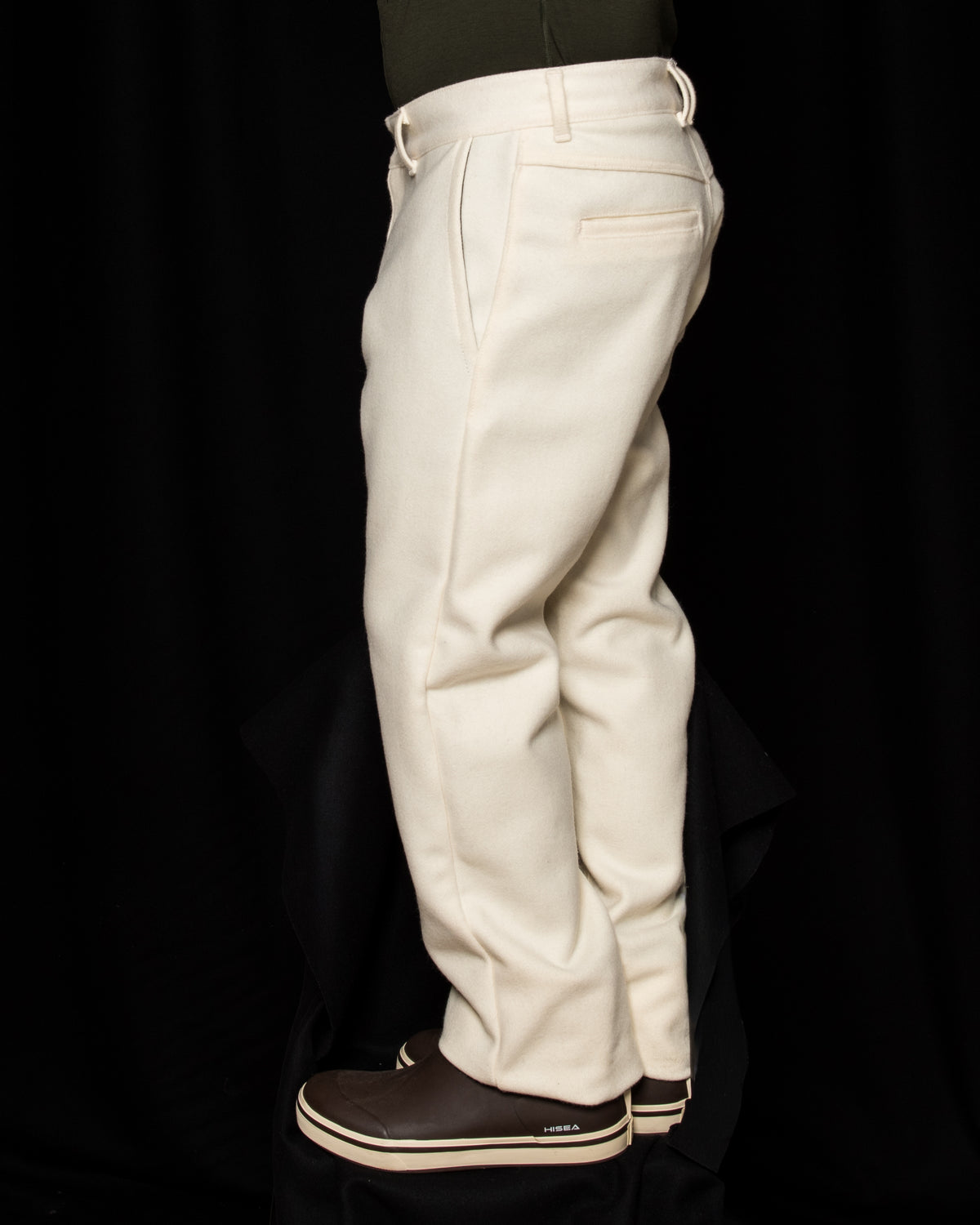 side view of White-out Tracker Pants 100% White wool on model wearing brown boots