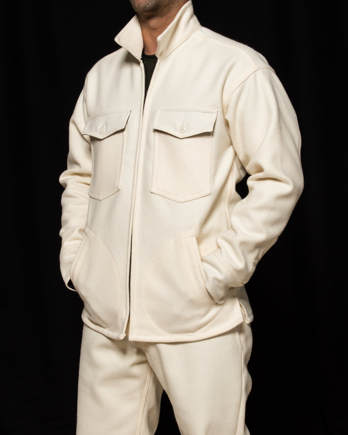 White-out Tracker jacket made from 100% white wool on model with hands in pockets
