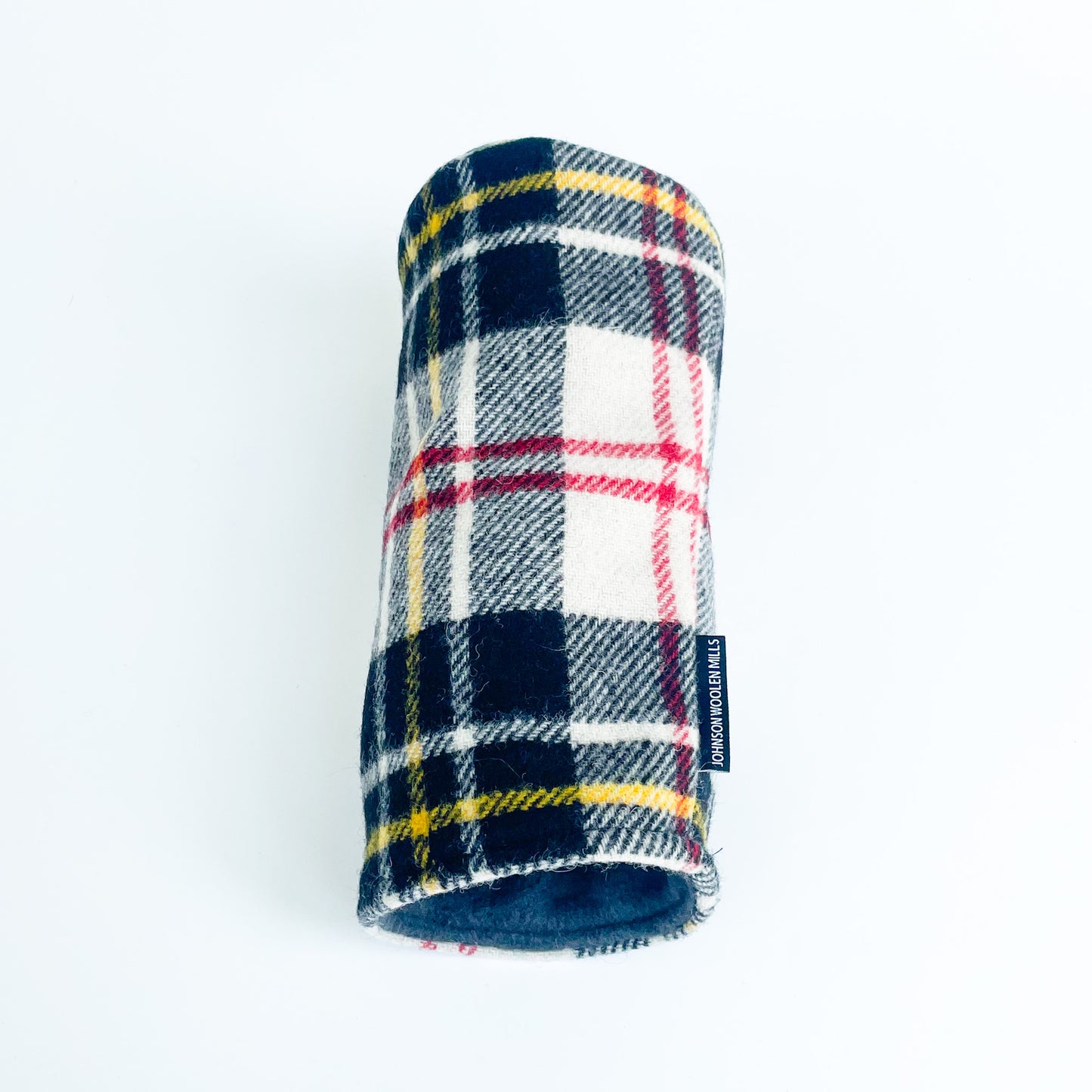 Black, White, yellow, red plaid wool driver headcover laying on side with fleece lining