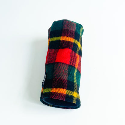 Bright red, green, and yellow plaid wool driver headcover laying on side