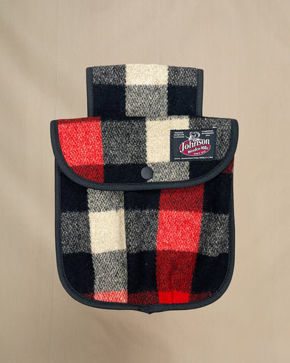 Plaid black powder hunting pouch with Johnson label on a beige background