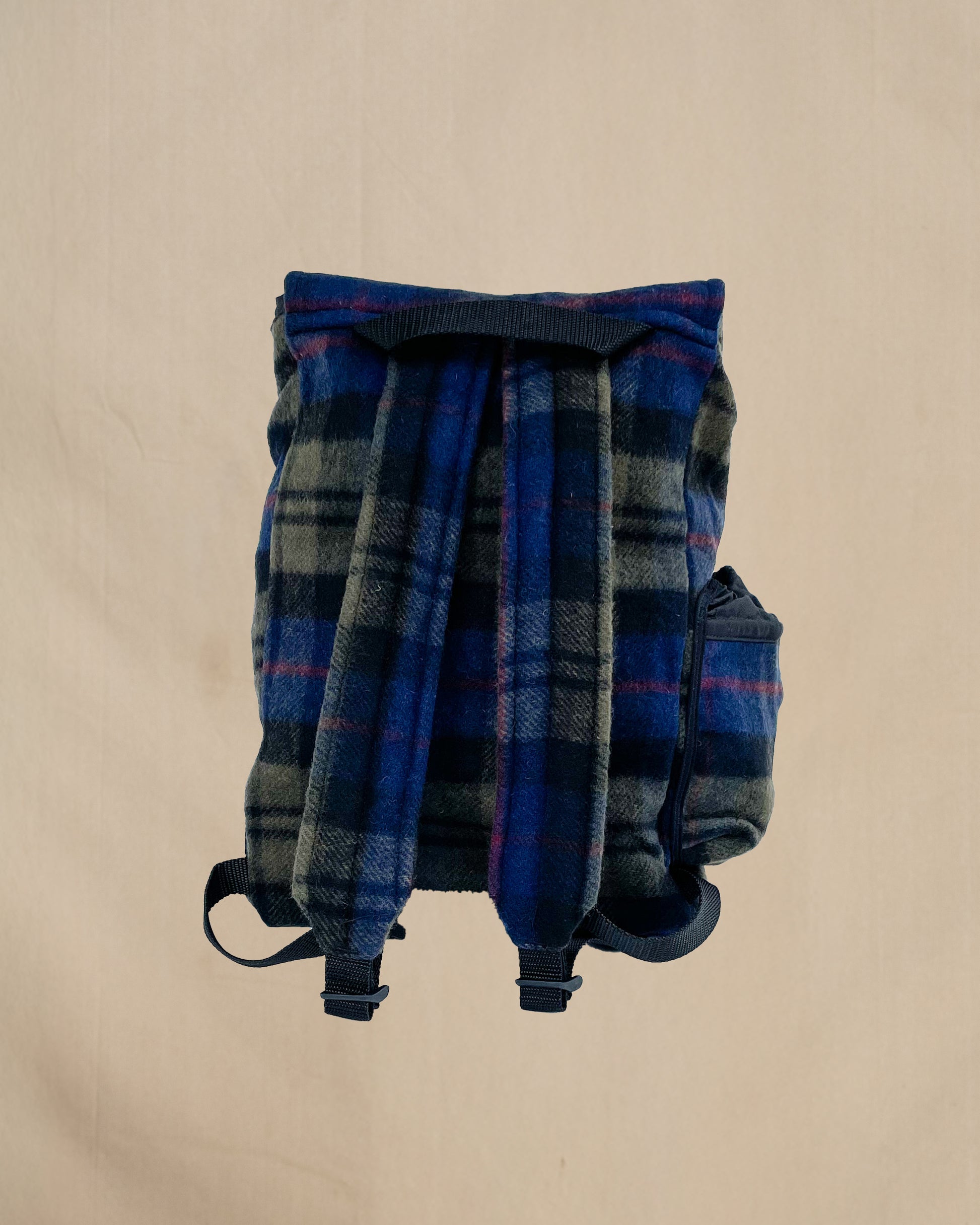 Blue and olive plaid wool backpack with side water bottle pocket, back view