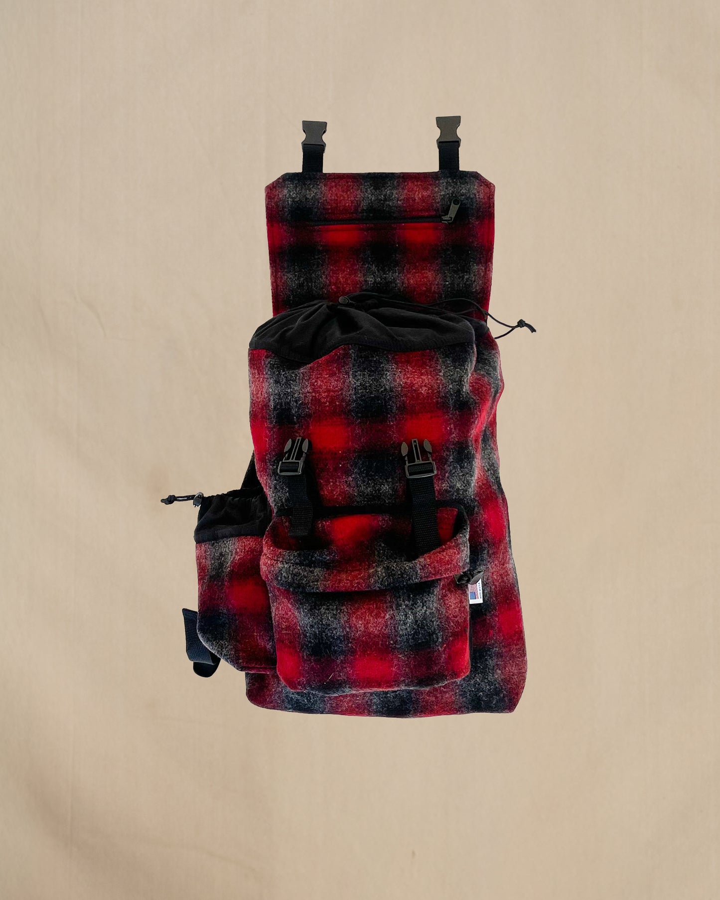 Wool back pack red , black and gray muted plaid with top flap open