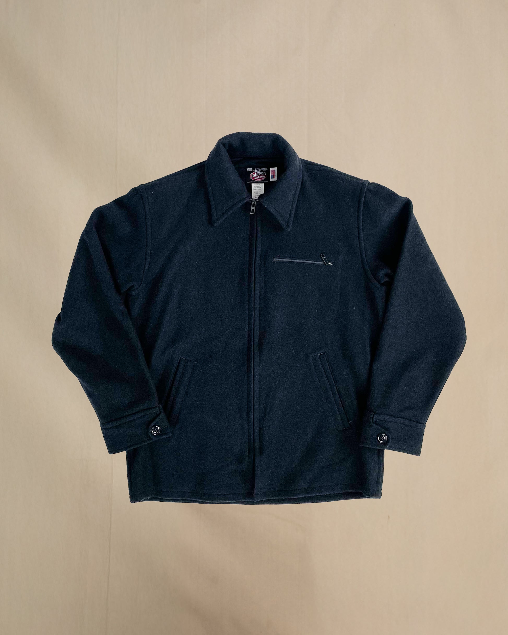 Navy jacket on a beige background