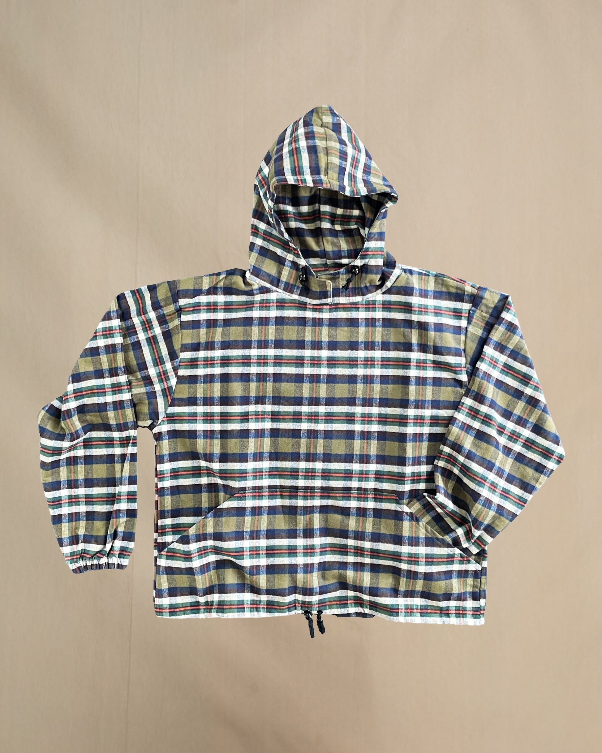 Plaid flannel hoodie on a beige background