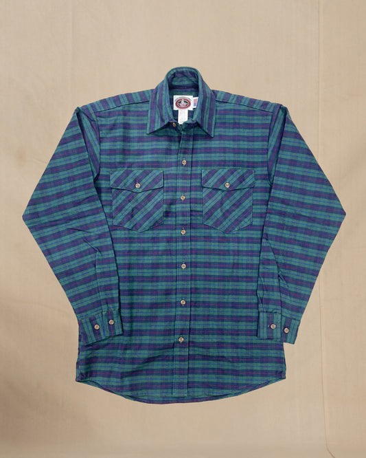 Green and blue plaid shirt on a beige background
