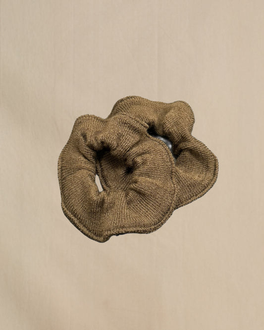 Brown scrunchie on a beige background