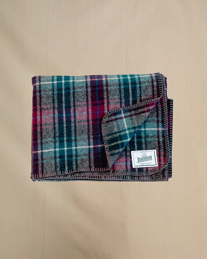 Johnson Woolen Mills Wine Gray Teel Plaid folded blanket showing logo patch