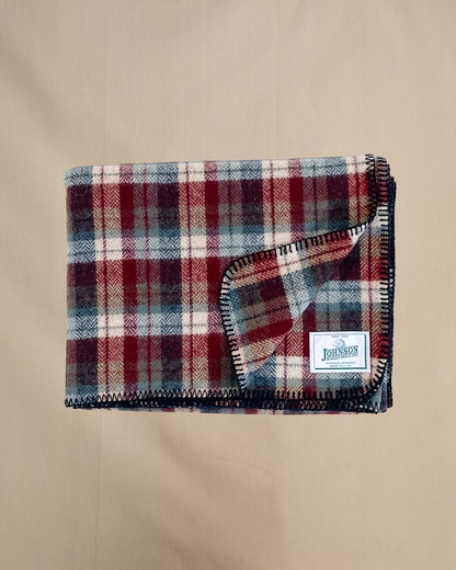 Johnson Woolen Mills Teal Rust Cream Plaid folded blanket showing logo patch