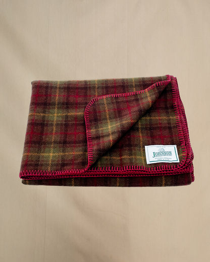 Johnson Woolen Mills throw - olive, brown, gold plaid with red stitching and logo 
