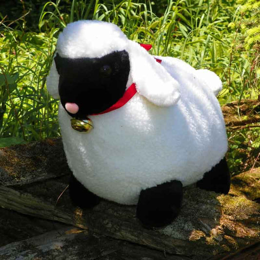 white plush sheep stuffed animal with red ribbon and bell
