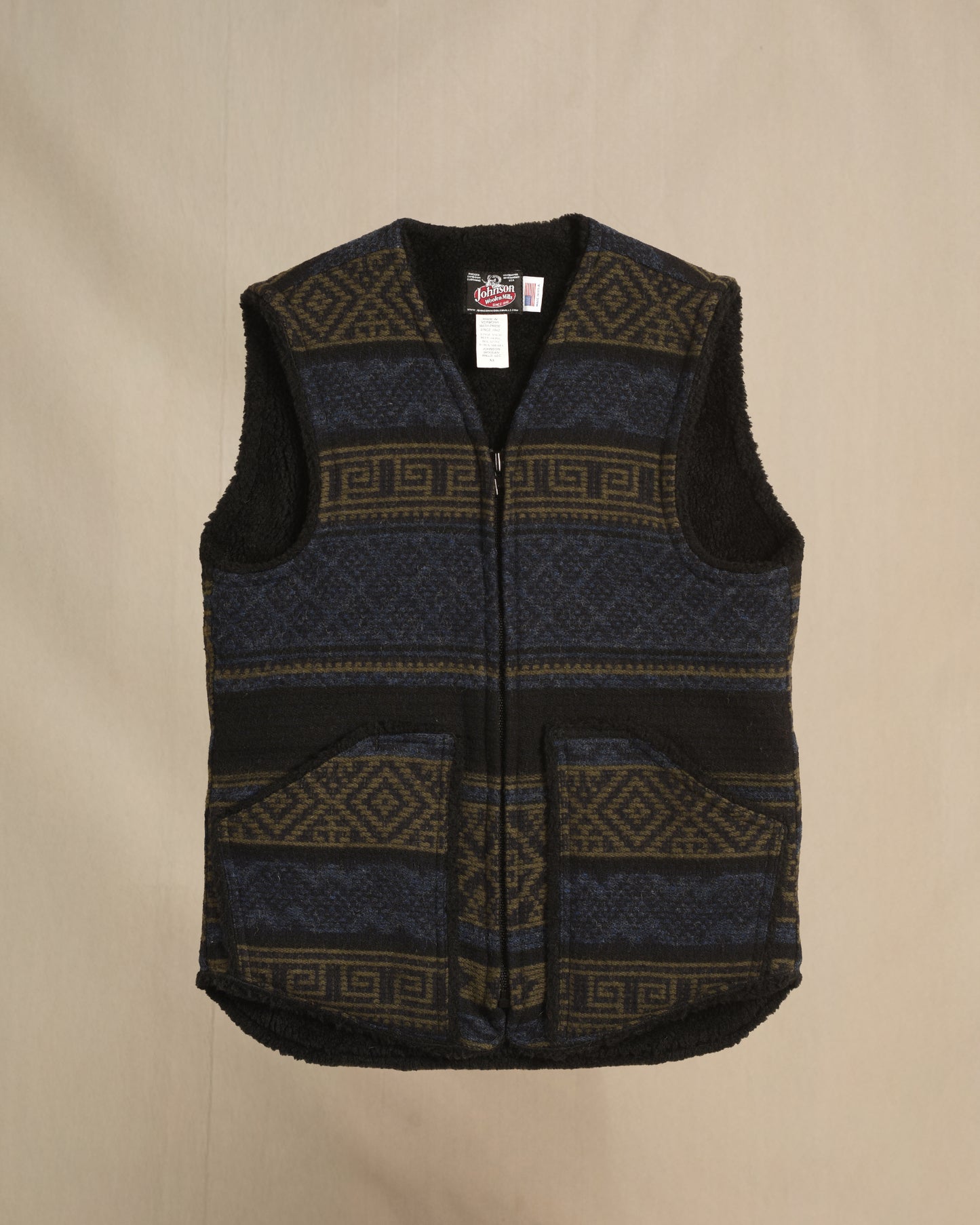 Vest with sherpa lining, blue/olive/black Aztec print, zipper front with two pockets, zipped front view