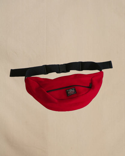 Wool fanny pack with zipper closure and nylon waistband with buckle, shown in scarlett red