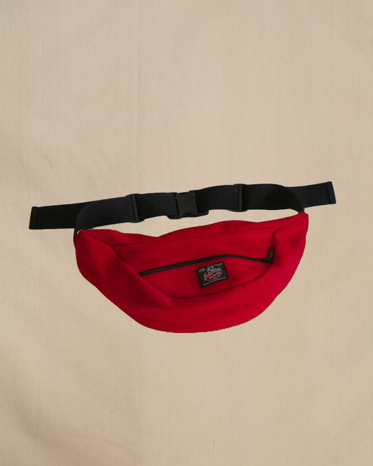 Wool fanny pack with zipper closure and nylon waistband with buckle, shown in scarlett red