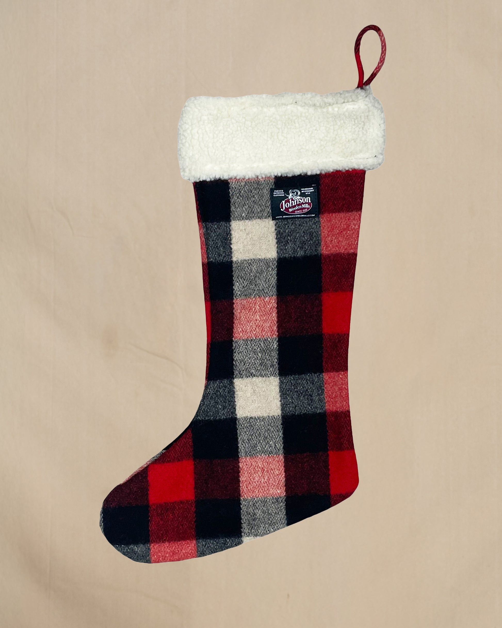Plaid Wool Christmas stocking with a pattern on a beige background