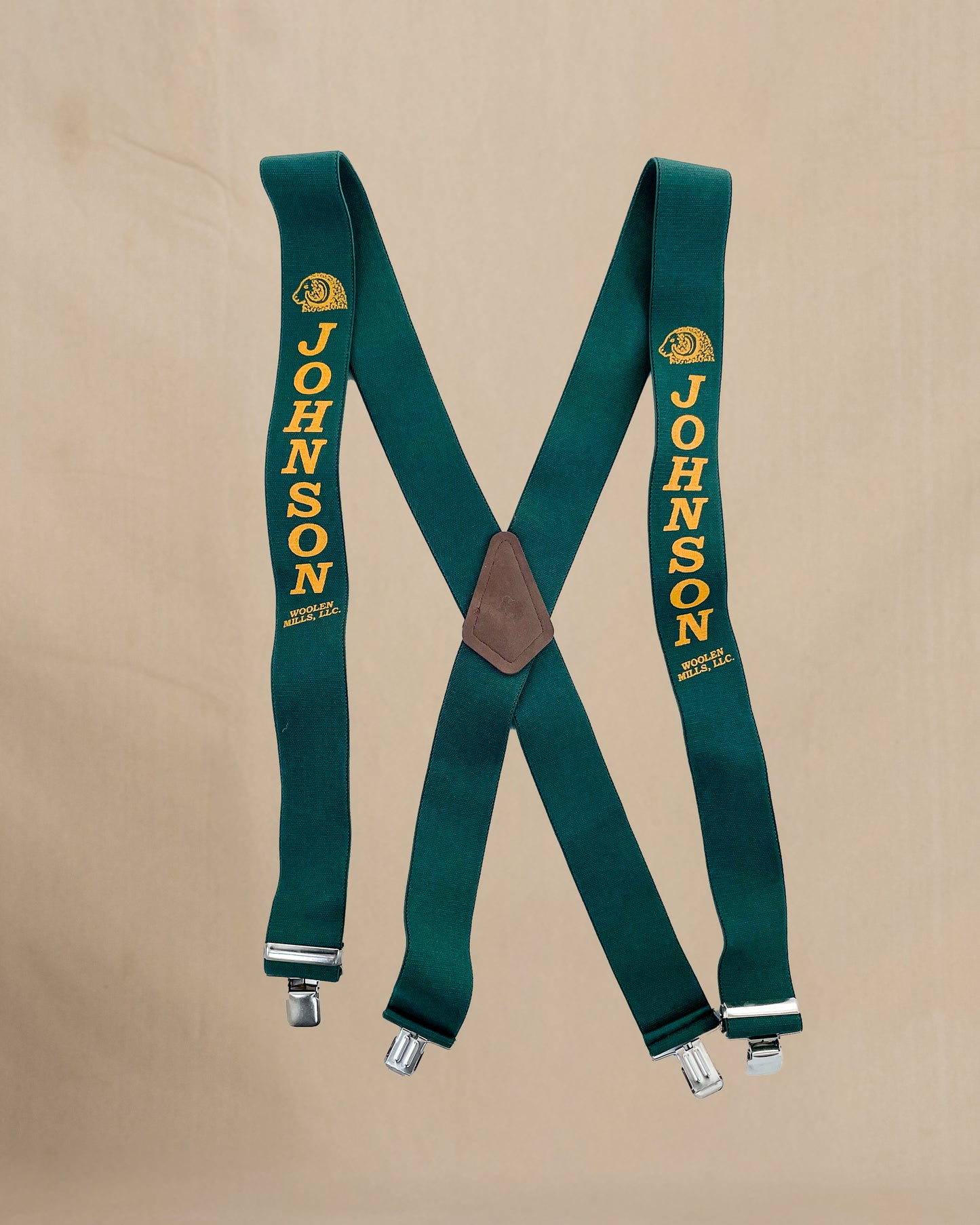 Green suspenders with 'Johnson' branding on a beige background