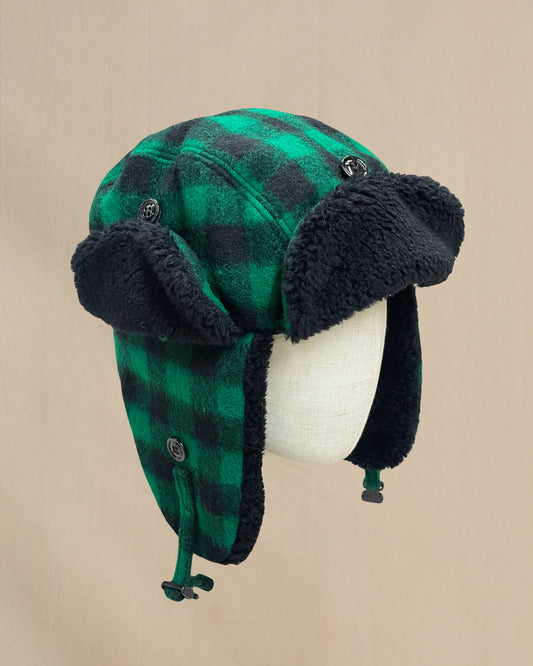Green and black buffalo plaid wool bomber style hat with black sherpa lining around rim and visor. Side view