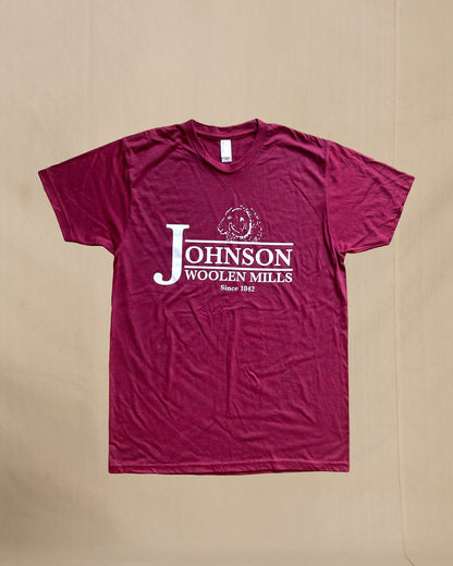 Maroon t-shirt with Johnson Woolen Mills logo on a beige background