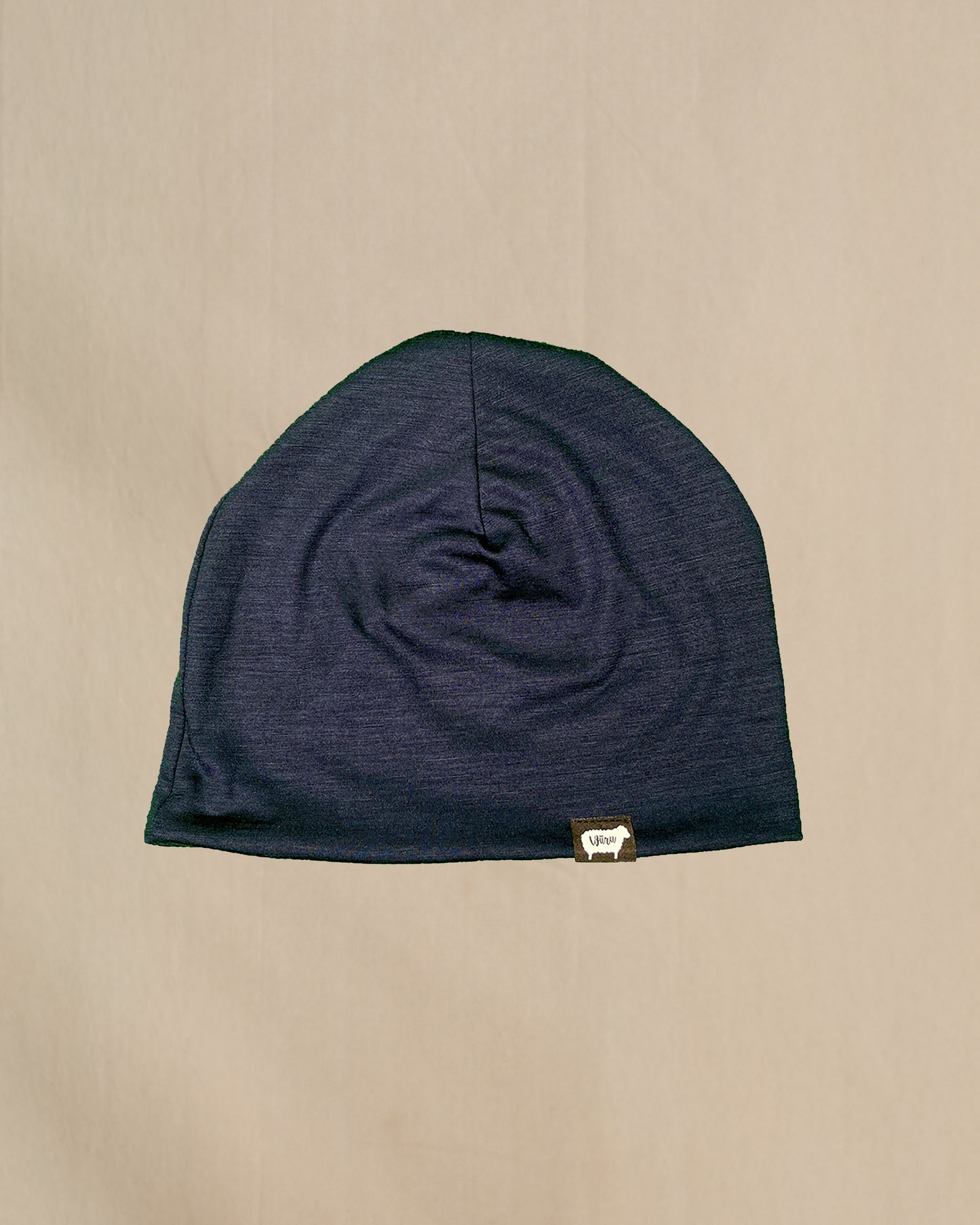 A black 100% Merino Wool Beanie with the Wuru.