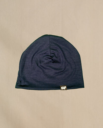 A black 100% Merino Wool Beanie with the Wuru.
