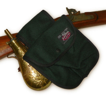 photo of spruce green black powder pouch with antique rifle 