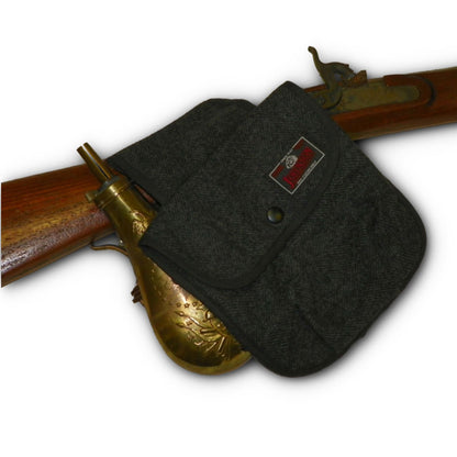 photo of gray herringbone black powder pouch with antique rifle 