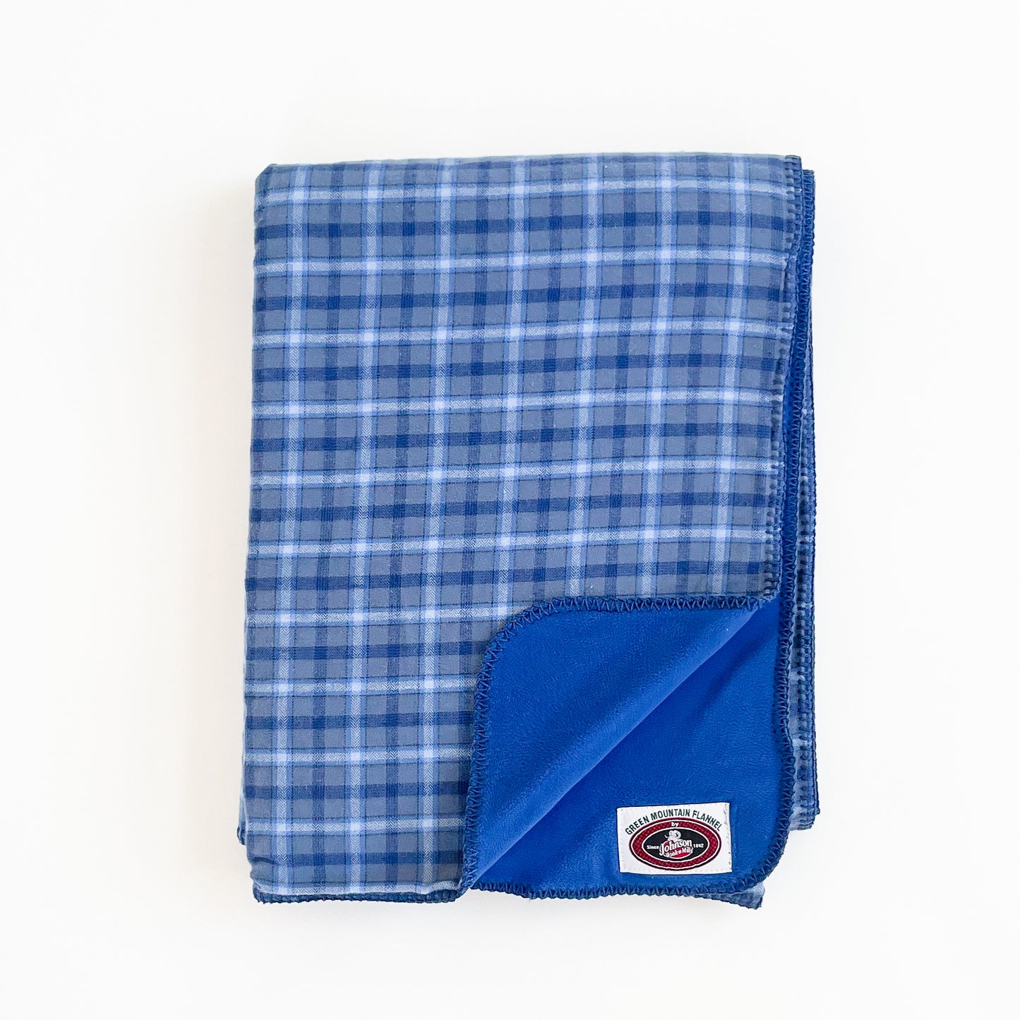 Green Mountain Flannel Throw Bluebird, light blue/dark blue/ white stripes with blue fleece lining open corner view