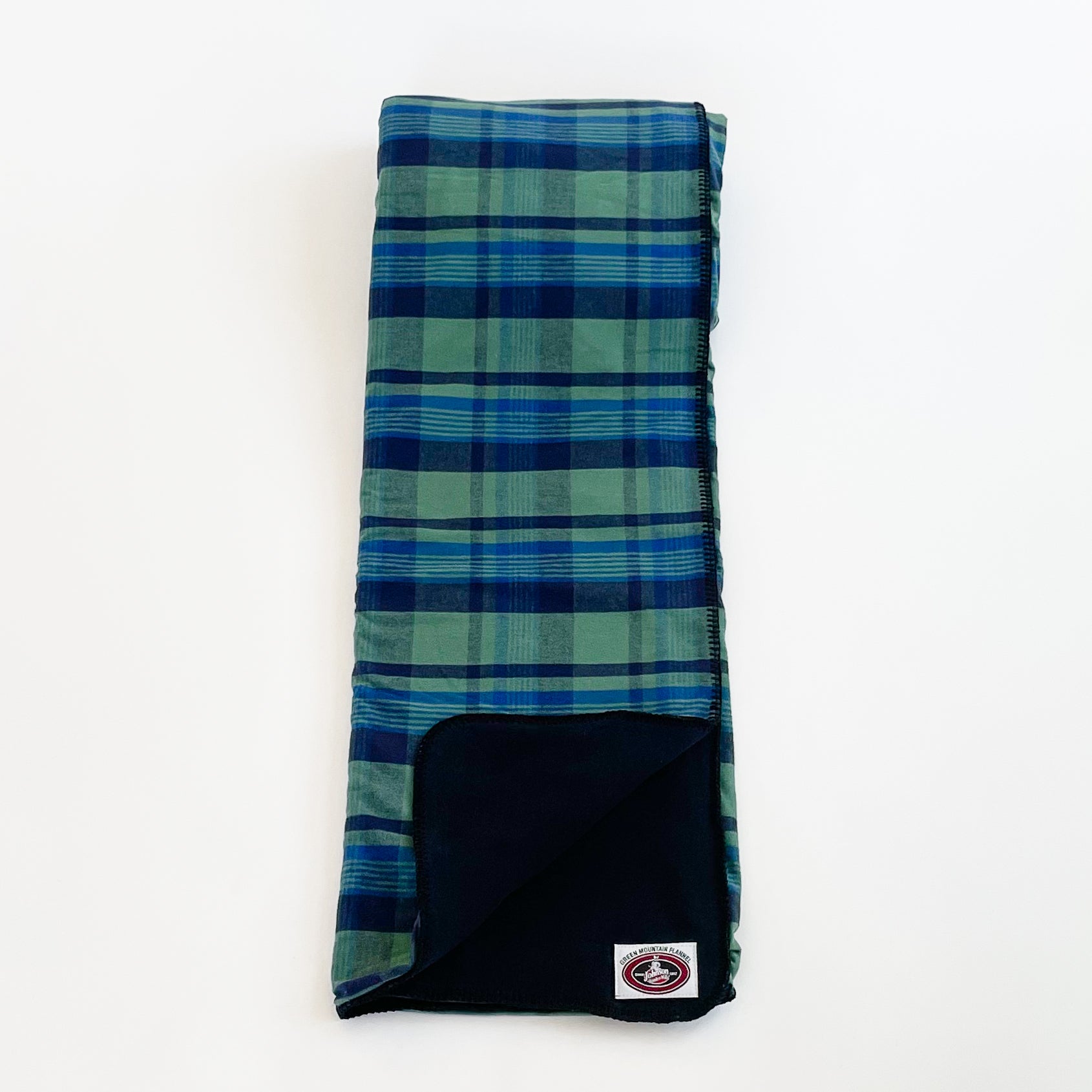 Green Mountain Flannel Throw Royal Navy & Green stripes with black fleece lining open corner view