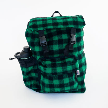 Wool back pack green and black buffalo plaid, shown with water bottle in side pocket