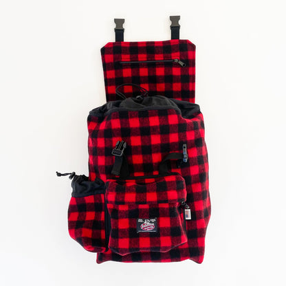 Wool back pack red and black buffalo plaid, shown with water bottle in side pocket and top flap open