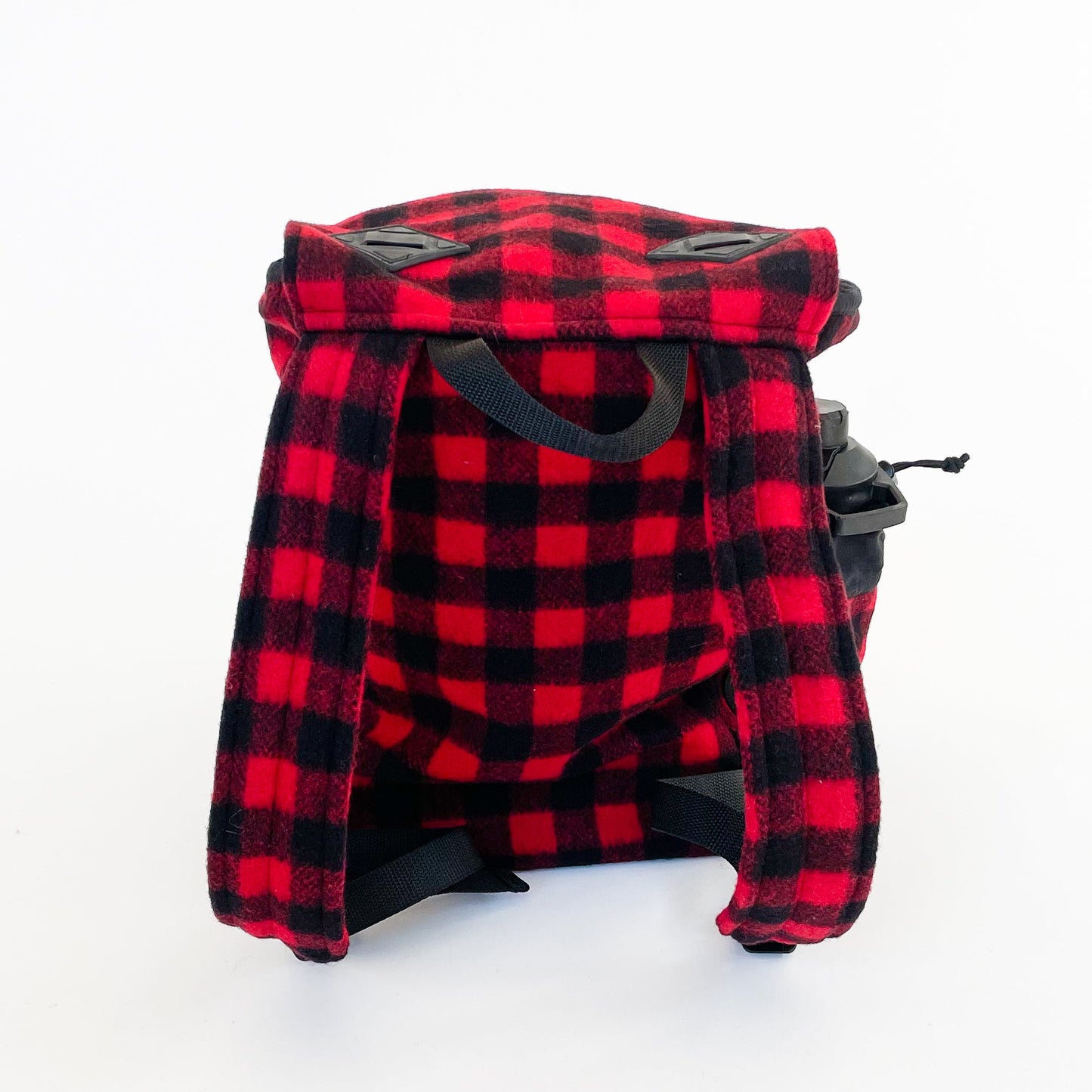 Wool back pack red and black buffalo plaid, shown with water bottle in side pocket - back view