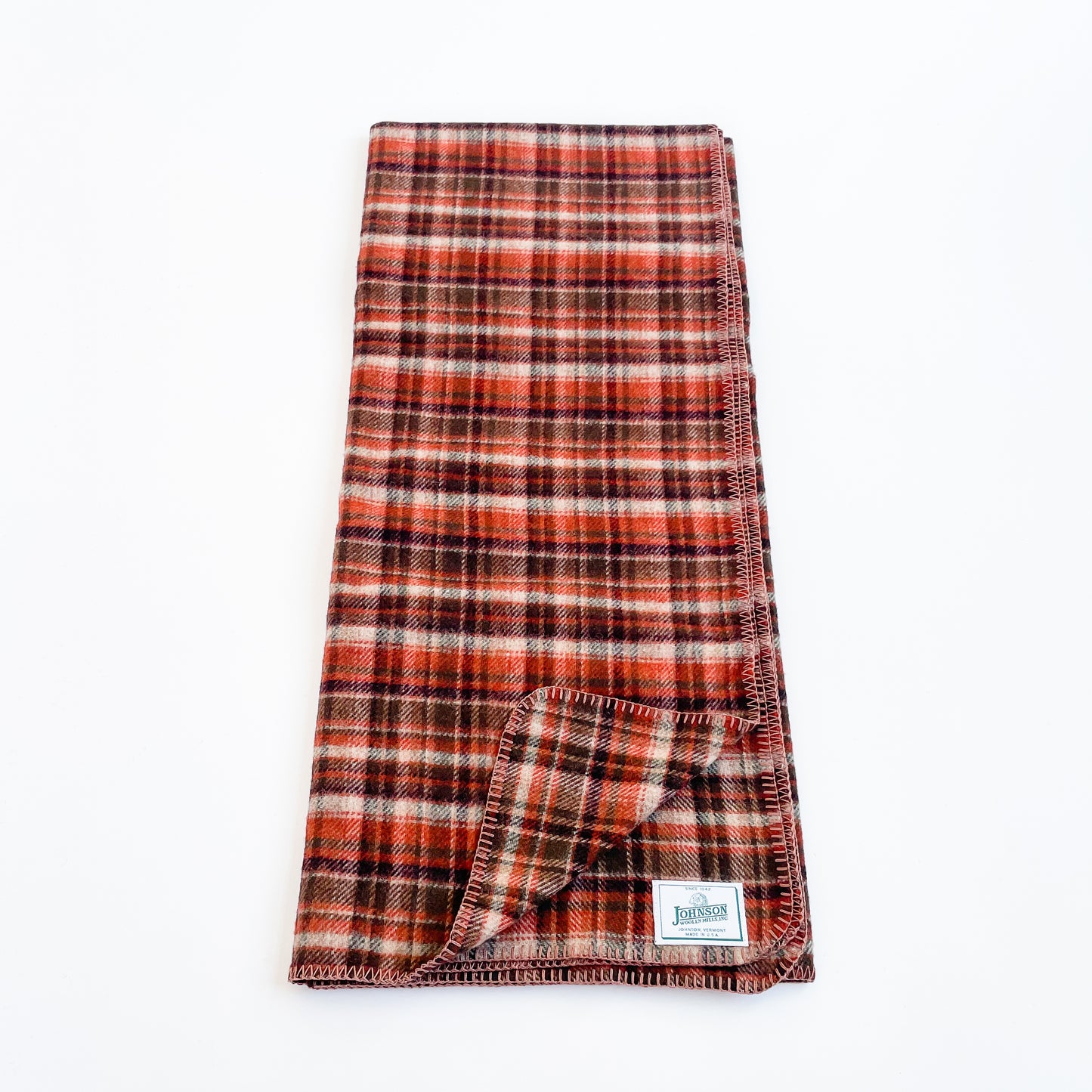 Johnson Woolen Mills Rust Tan Brown Plaid folded blanket length wise front view 