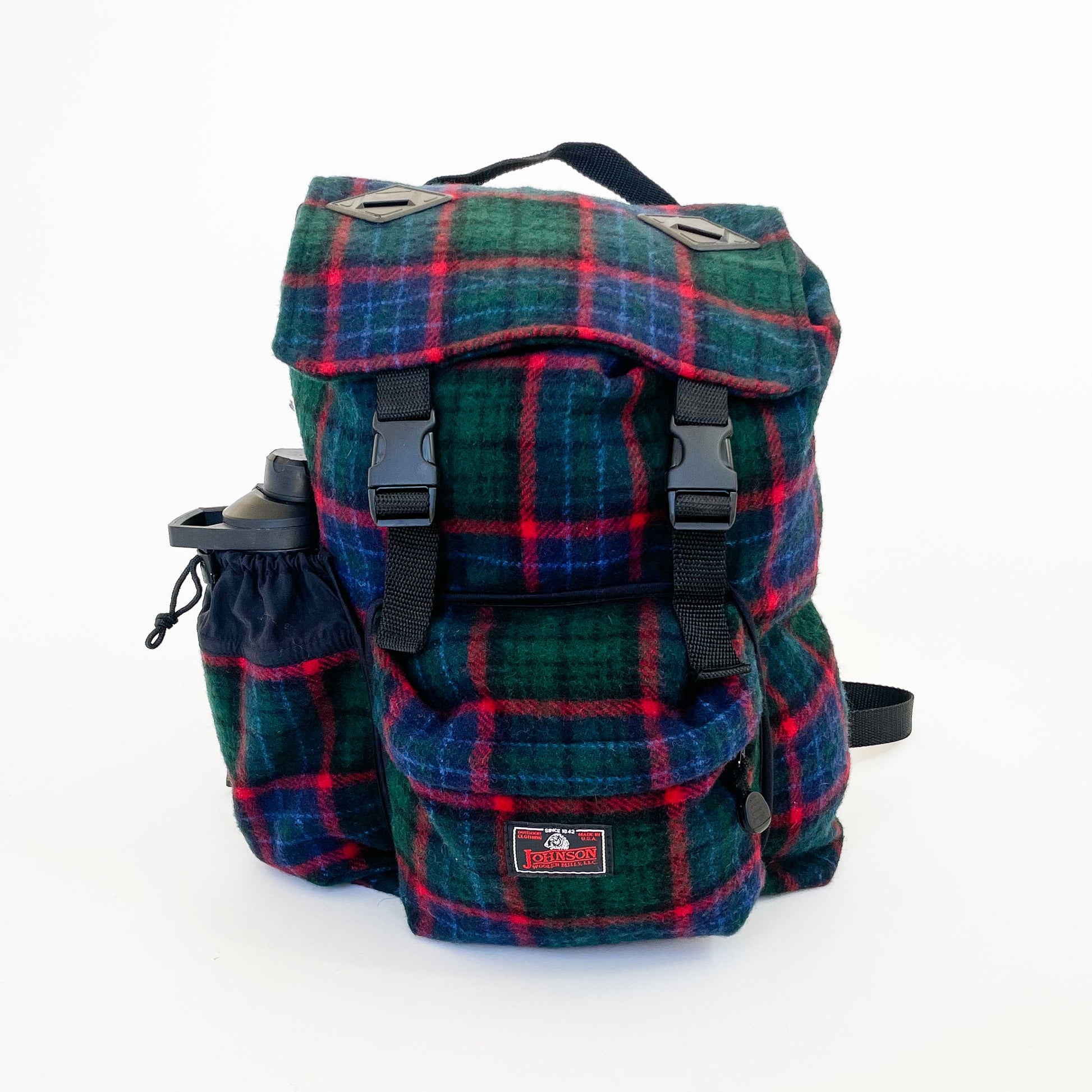 Wool back pack green and blue with red windowpane print, shown with water bottle in side pocket