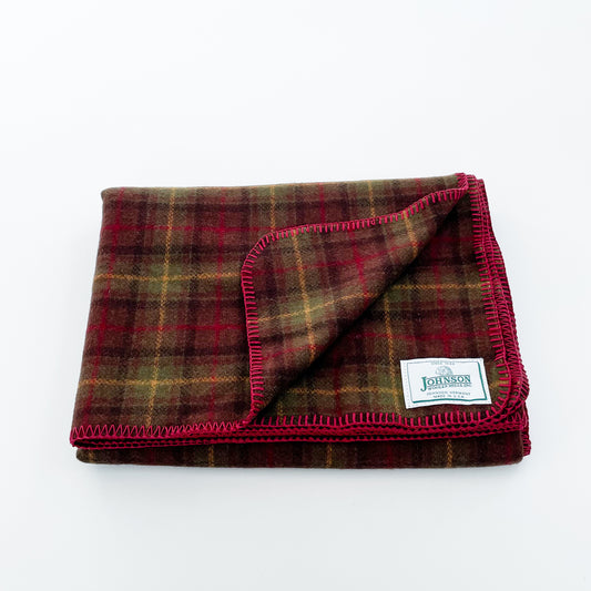 Johnson Woolen Mills throw - olive, brown, gold plaid with red stitching and logo 