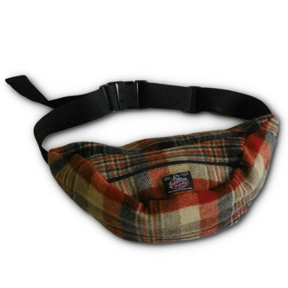 Wool fanny pack with zipper closure and nylon waistband with buckle, shown in rust, black and tan plaid