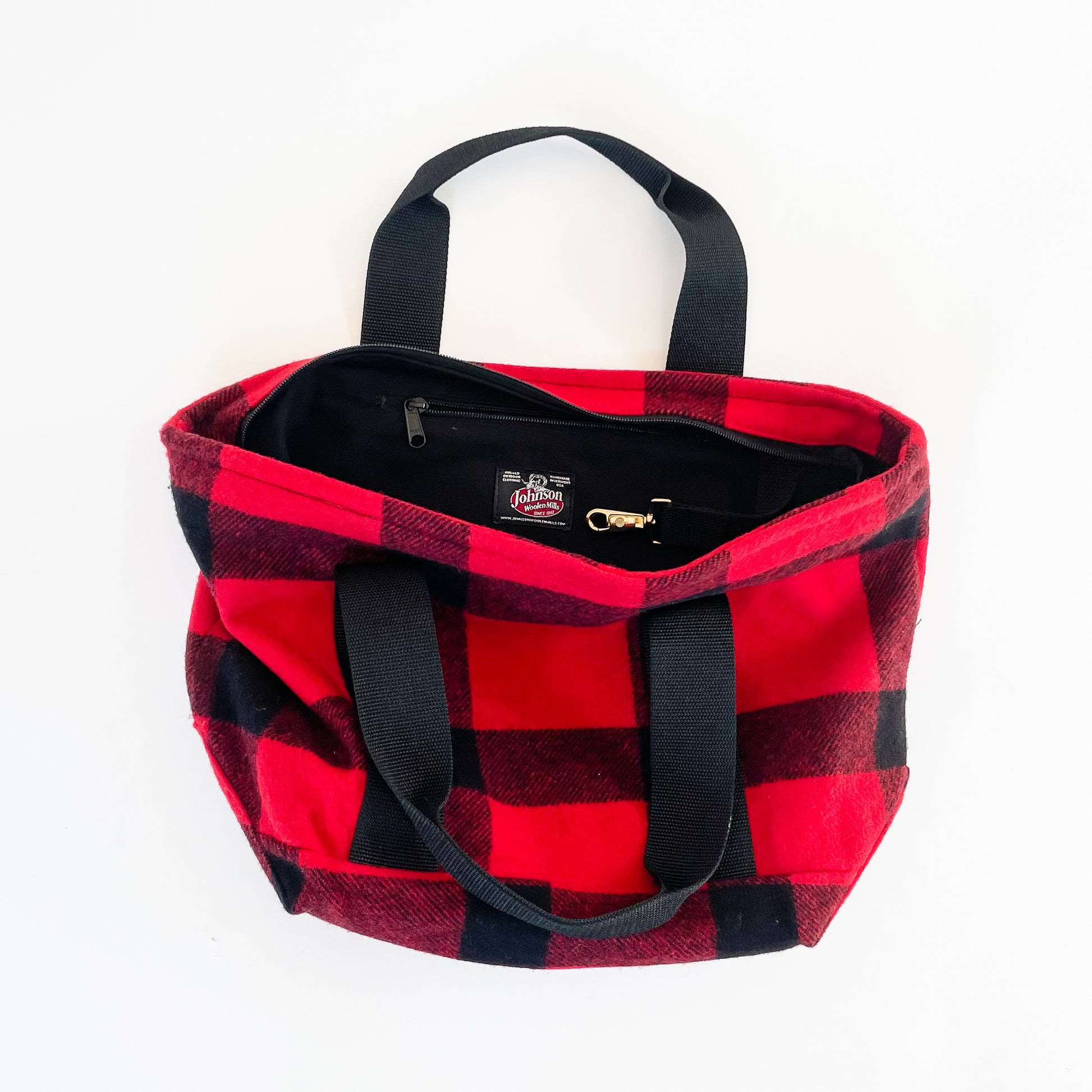 Wool bucket tote bag, large red and black plaid, shows full zipper top with inside pocket and key holder, and nylon straps