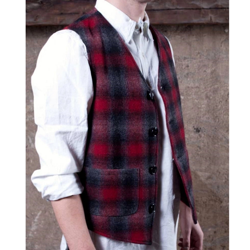 Vest with four brushed nickel buffalo buttons, red/black/gray muted plaid, two lower pockets, unbuttoned side view on model
