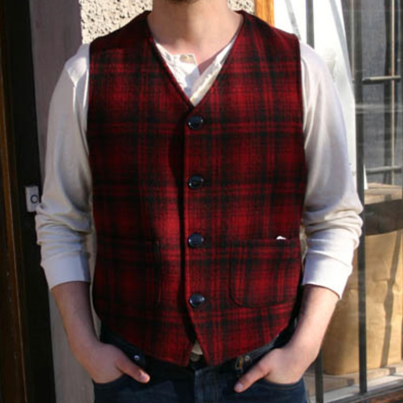 Vest with four brushed nickel buffalo buttons, red & black muted plaid, two lower pockets, buttoned front view on model